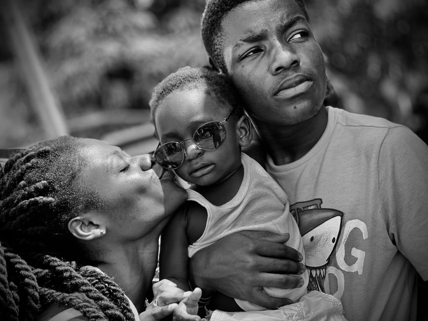 A Haitian family holding each other close